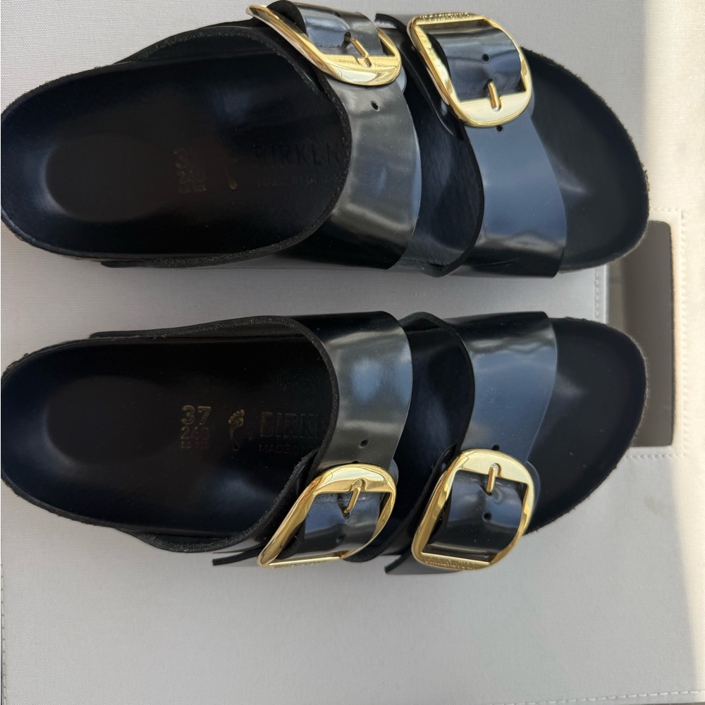 Birkenstock Glossy Black Sandals with Gold Accents